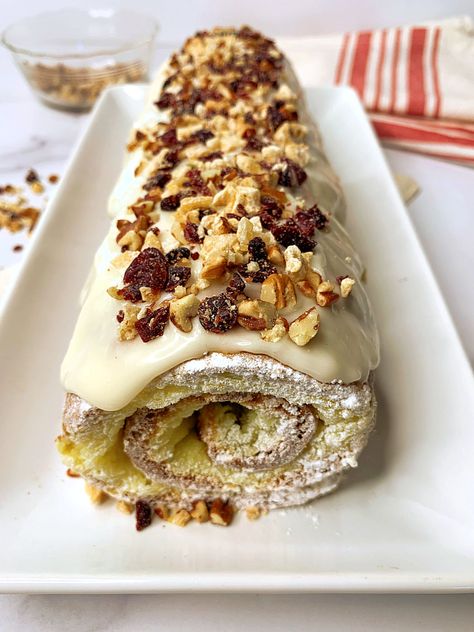 Try this amazing Banana Cake Roll with a sweet cream cheese filling and lots of crunchy pecans, candied ginger, and dried cranberries. The banana sponge cake and the filling bake together to make rolling the cake super easy. This cake is impressive but so simple to make. Pecan Cake Roll Recipe, Banana Swiss Roll Recipe, Banana Nut Roll Cake, Banana Cake Roll With Cream Cheese Filling, Banana Swiss Roll, Banana Sponge Cake, Banana Roll, Pumpkin Sheet Cake, Nut Rolls