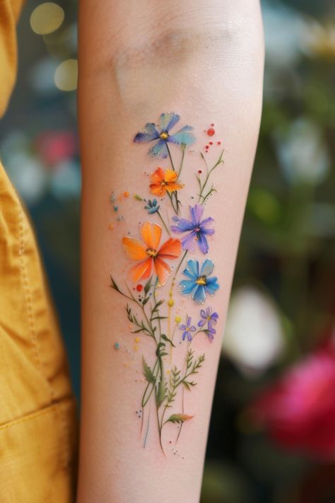 Prepare to be enchanted by a stunning collection of 21 feminine floral color tattoos that will leave you breathless. These exquisite designs showcase the beauty and versatility of vibrant botanical elements, offering a captivating way Wildflowers Tattoos, Watercolour Tattoo For Women, Feminine Flower Tattoos, Watercolor Flower Tattoo, Flower Tattoos For Women, Wildflowers Tattoo, Colorful Flower Tattoo, Flower Wrist Tattoos, Wildflower Tattoo