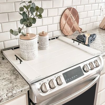 Imagine adding 30 inches of extra counter space to your kitchen. Handmade noodle boards are the perfect way to make better use of your stovetop. Although not food-grade, these wooden stove covers are definitely decor-grade. Use a kitchen stove cover to upgrade the look of your stovetop by hiding the unsightly burners and decorating with your favourite spices and kitchen decor. This farmhouse-inspired wooden burner cover has been finished in a variety of colours to highlight both the natural wood Stove Covers, Wooden Stove, Wooden Stove Top Covers, Noodle Boards, Noodle Board, Stove Top Cover, Burner Covers, Glass Cooktop, Entry Tables