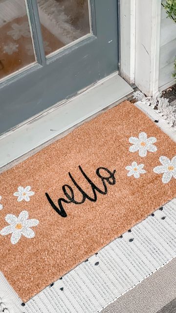 Nikki Muhilly | Realtor ® on Instagram: "The weather isn’t cooperating but that’s not stopping me from bringing some spring decor to the porch. @nickeldesigns has did it again with their custom doormat and layering rug! I’m obsessed with the daisies on this doormat. I love layering my doormats with rugs and @nickeldesigns has such a great variety! They even take custom orders! You can use code HEYSPRING for 15% off! Are you doing a spring decor refresh? Tell me below! #gifted #nickeldesigns" Spring Doormat Diy, Spring Doormat Ideas, Spring Door Mat Ideas, Doormat Painting, Doormat Aesthetic, Door Matts, Front Porch Furniture Ideas, Spring Door Mat, Porch Furniture Ideas