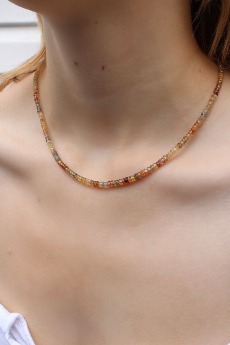 The gradient of this zircon-beaded necklace captures the turn of seasons. 'Solstice' reminds us of impermanence and the beauty that comes with such fluidity. As summer unfurls into autumn, the colours of these faceted beads carry earth tones of amber, brown, buttery yellow and pale blues, reflecting such changes. Hand-strung and designed by us in our flagship store in Vancouver, BC, we personally sourced these zircon beads with the intention of creating a piece that is wearable and uniquely yours. The piece is finished with a sturdy 10k yellow-gold lobster clasp. Enjoy this pretty beaded necklace paired with your favourite gold chains and charms. Details: 10k yellow gold lobster clasp + Zircon beads 16.5" in length Code: ZIRCON165 (TAE) Beaded Chain Necklaces, Necklace Beads Design, Autumn Beaded Necklace, Autumn Beaded Jewelry, Earth Tone Jewelry, Brown Pearl Necklace, Fall Bead, Autumn Jewelry, Amber Bead Necklace