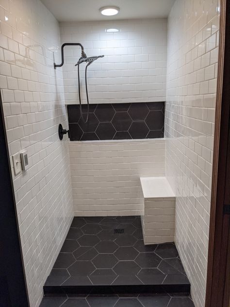 Walk In Shower Floor Ideas, Vertical Tiles In Showers, Farmhouse Bathroom Tile Shower Ideas, Dark Shower Aesthetic, Black Tile Shower With Bench, Dark Tile Shower Ideas, White Subway Tile Shower Gray Hexagon Floor, Hexagon Tile Bathroom Shower Wall Lowe's, Shower Floor Tiles