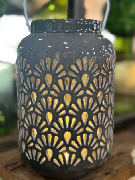 Light up your space with our elegant and exclusive 8" LED Shell Ceramic Lantern. Crafted with intricate shell detailing, this lantern creates a warm and inviting atmosphere with its soft LED light. Perfect for any room or outdoor area, add a touch of luxury to your decor. 8”H X 4”W Pierced Lantern Ceramics, Ceramic Lantern Ideas Clay, Ceramic Lantern Ideas, Shell Ceramics, Pottery Lantern, Ceramic Luminaries, Pottery Luminaries, Clay Lantern, Ceramic Luminary