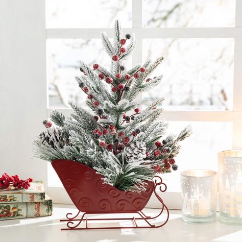 "Buy this Glitzhome® 21\" Christmas Red Sleigh Frosted Floral Centerpiece at Michaels. com. This floral centerpiece features high quality plastic artificial green pine needle branches, red and black foam berries, and natural pinecones in a sleigh adding festive joy to your home during the holiday. This floral centerpiece features high quality plastic artificial green pine needle branches, red and black foam berries, and natural pinecones in a sleigh adding festive joy to your home during the hol Country Christmas Crafts, First Snowfall, Centerpieces Diy, Home Parties, Christmas Floral Arrangements, Christmas Sleigh, Floral Centerpiece, Xmas Tree Decorations, Christmas Greenery