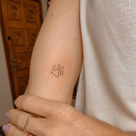 Outline Paw Tattoo, Fineline Dog Paw Tattoo, Cute Dog Tattoos Simple, Dog Arm Tattoos For Women, Dainty Dog Paw Tattoo, Simple Paw Print Tattoo Outline, Delicate Dog Paw Tattoo, Dog Paw Minimalist Tattoo, Dog Tattoo Ideas Minimalist Paw