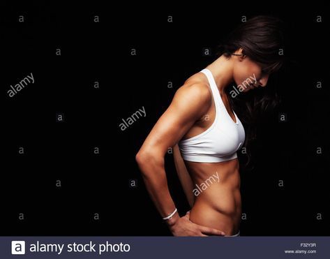 Side view of fitness female model standing with her hands on hips against black background. Muscular young woman. Stock Photo Model Standing, Woman Stock Photo, Woman Sketch, Hands On Hips, Female Model, Side View, Young Woman, Pose Reference, Face And Body