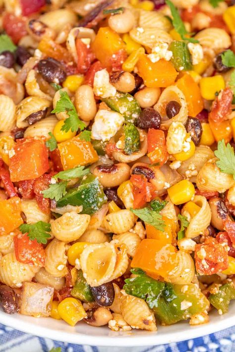 Cowboy Caviar Pasta Salad Recipe - inspired by our favorite dip! Cold pasta salad loaded with veggies, beans, and feta cheese and tossed in a light and tangy dressing. Flavorful, fresh, and hearty enough to feed a crowd. Pasta, bell peppers, onion, corn, black beans, black-eyed peas, Rotel, cilantro, olive oil, lime juice, chili powder, paprika, cumin, red wine vinegar, honey, and feta. Cowboy Caviar Pasta Salad, Cowboy Caviar Pasta, Caviar Pasta, Mac And Cheese Pasta, Black Bean Corn Salad, Greek Pasta Salad Recipe, Cilantro Recipes, Best Macaroni Salad, Pasta Salad Dressing