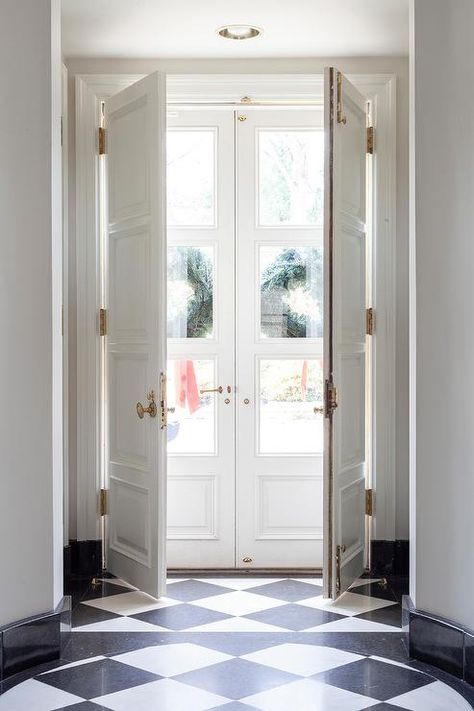 White Double Doors Exterior Entrance, Narrow Double Doors Entrance, Black And White Flooring, Company Photography, Double Door Entryway, Double Door Entrance, White Beadboard, Front Door Hardware, Double Doors Exterior