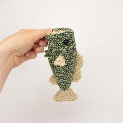 PLEASE NOTE: THIS PURCHASE IS ONLY FOR A DIGITAL CROCHET PATTERN, NOT THE FINISHED ANIMAL Create your own largemouth bass in under 2 hours! This easy-to-follow pattern includes detailed instructions, pictures, and video tips on how to crochet and assemble all the parts to make this bass.  This pattern uses the following stitches: chain, single crochet, double crochet, half double crochet, and the slip stitch Materials You Will Need     * Crochet hook size: 3.75mm     * #4 medium worsted weight yarn*: speckled or solid green (for the body), light peach/pink (for the mouth), and tan (for the fins)     * Yarn needle     * One pair of 12 mm safety eyes     * Polyester fiber fill stuffing Final measurement for the finished bass is 7.75 inches (or 20 cm) long. *Guess what? This listing also incl Crochet Trout Fish, Crochet Bass Fish Pattern Free, Bass Crochet Pattern, Easy Crochet Gifts For Men, Crochet Bass Fish, Crochet Fish Pattern Free, Crochet For Men, Crocheted Fish, Fish Crochet