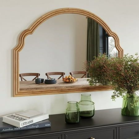 Experience a fusion of rustic charm and contemporary elegance with the Regina Wide Arch Natural Tone Wood Wall Mirror. The frame, bathed in a rich natural brown hue, captures the authentic beauty and texture of wood, presenting an alluring wall mirror that's as much a decorative piece as it is functional. Its expansive arch, characteristic of large mirror designs, adds a touch of drama, making it an ideal focal point for any space. Whether you're aiming for a farmhouse mirror look in your living room or seeking a timeless piece for your bedroom, this natural wood mirror stands as a testament to refined style and taste. Size: 30" H x 41.25" W x 1.25" D. Mirror Over Fireplace, Farmhouse Mirror, Farmhouse Mirrors, Wood Framed Mirror, Wood Wall Mirror, Accent Mirror, Light And Space, Wood Mirror, Framed Mirror Wall