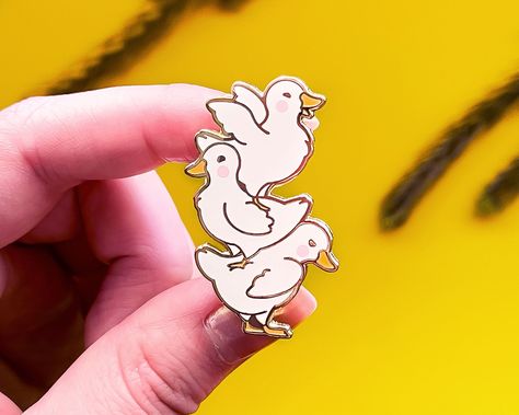 This funny and adorable mini ducks quack stack enamel pin features my drawing of three cute ducks standing on each other. This pin is based on my original Quack Stack vinyl sticker. This 1.75" hard enamel pin features gold plating and has two posts on the back. PICK YOUR PIN BACK I ship my pins with custom colored rubber pin backs by default. If you would like a locking (deluxe) metal pin back, please choose the Locking Pin Back option when you go to add the pin to your cart. Locking pin backs a Cute Ducks, 75 Hard, Duck Pins, Cute Patches, Friends Are Like, Cute Little Drawings, Hard Enamel Pin, Metal Pins, Cute Pins