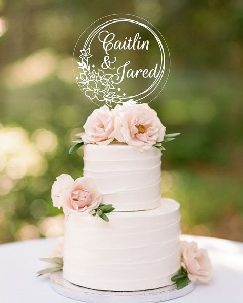 "This personalized round cake topper is cut from clear acrylic and laser engraved with a beautiful floral design with your personalized text for a lasting piece to use year after year. Choice of 4\" or 6\" in circumference to fit your cake perfectly. ------------------------------------------------------------------------------ 15% off coupon code HERE -> https://linktr.ee/AmyPotts 15% off coupon code HERE -> https://linktr.ee/AmyPotts 15% off coupon code HERE -> https://linktr.ee/AmyPotts ----- Acrylic Wedding Cake Topper, 2 Tier Wedding Cakes, Topper Floral, Circle Cake, Mr Mrs Cake Toppers, Floral Cake Topper, Decor Cake, Simple Wedding Cake, Elegant Wedding Cakes