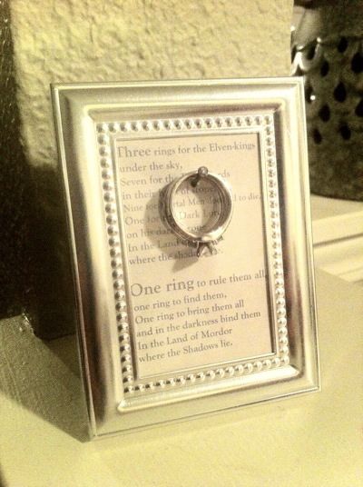 Homemade ring holder using a small frame. The frame idea was from Pinterest--the LOTR quote was my own idea :) You could use any quote you like, really. Lotr Quote, Ring Warming, Small Wedding Rings, Ring Frame, Craft Display, Diy Holder, Three Rings, Small Frame, One Ring