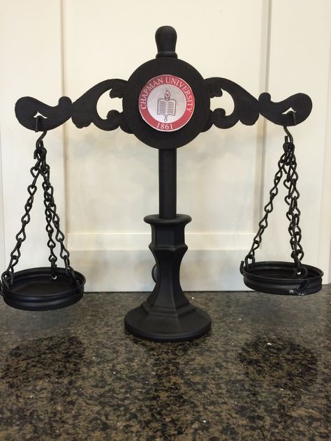 This is a back view of our Justice Scale Centerpiece.  Black chain was from Home Depot with chalkboard mason jar lids from Michaels. A copy of Chapman University's school insignia adds a final touch. Diy Scales Of Justice, Diy Scales, Smu Graduation, Law School Graduation Party, Chalkboard Mason Jars, Justice Scale, Law Office Decor, Law School Graduation, Scales Of Justice