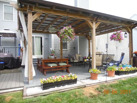 Tin roof pergola with curtains and imagine this. . . A colonial provincial style rustic chandelier hanging from it. And an inviting table with the grill going off to the side. ahhhhh bliss.. Tin Roof Patio, Pergola Trellis, Pergola Metal, Roof Patio, Outdoor Covered Patio, Farmhouse Patio, Rustic Porch, Pergola Design, Covered Pergola