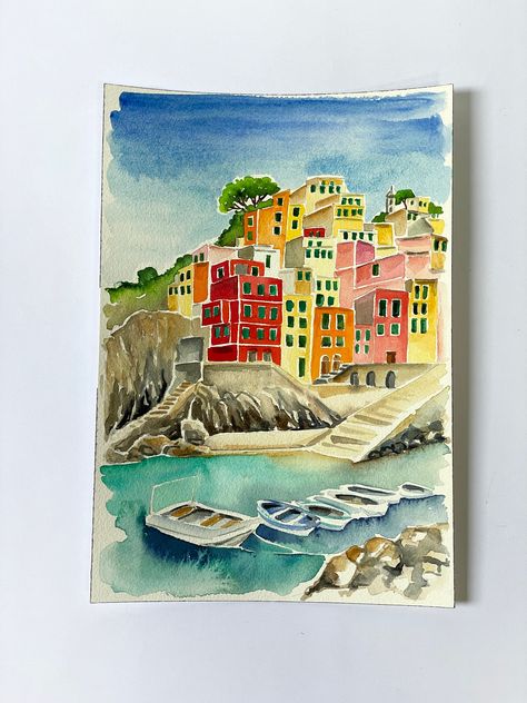 Original watercolor of Cinque Terre, Italy. This watercolor depicts the town of Riomaggiore with its characteristic houses, the sea and boats. Painting on watercolor paper, painting for lovers of Italy, gift for lovers of Italian countries. Landscape Watercolor On Paper 18x26 cm. Watercolor painting hand drawn by a professional painter. The painting is original and all handmade, the paper I used is Arches fine-grained 300 g / m and measures 18x26 cm (7x10 inches). The painting is not framed, it Akvarel Illustration, Boats Painting, Italy Gift, Watercolor Architecture, Italy Painting, Cinque Terre Italy, Italian Landscape, Diy Watercolor Painting, Watercolor Painting Techniques