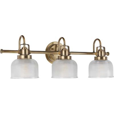 Shop Progress Lighting Archie 26.25-in 3-Light Vintage Brass Transitional Vanity Lightundefined at Lowe's.com. Create a vintage-inspired look by adding the Archie three-light bath to a bathroom or dressing table mirror, in a hallway, or wherever task light is needed. Transitional Vanity, Vintage Knobs, Table Mirror, Dressing Table Mirror, Progress Lighting, Bath Vanity Lighting, Bath Light, Wall Fixtures, Bath Vanity