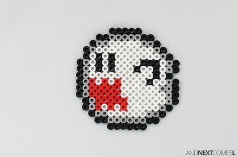 Super Mario World ghost boo perler bead craft from And Next Comes L Nintendo Switch Perler Bead Patterns, Boo Perler Beads, Perler Bead Ghost, Super Mario Perler Bead Patterns, Horror Perler, Alt Crafts, Hama Beads Halloween, Handmade Tale, Mario Crafts