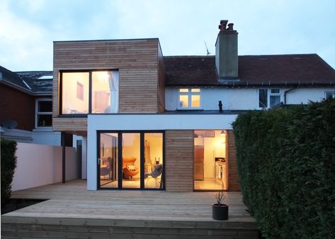 A contemporary two storey extension located in Winchester. The proposal  looked to redesign the existing 1900's house in a way more suited to  contemporary living. The first floor element cantilevers from the house,  providing parking underneath, whilst the ground floor extension tucks  neatly underneath, opening out into the garden. Architecture Extension, 1900s House, Flat Roof Extension, House Extension Plans, Roof Extension, Modern Extension, Extension Designs, Rear Extension, House Extension Design