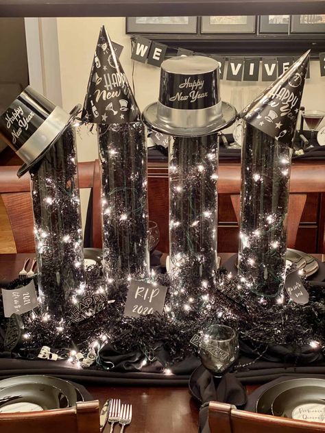 Nye Table Centerpiece, Silver And Black New Years Eve Party, New Years Eve Table Centerpieces, New Year’s Eve Table Centerpiece, Black And White Nye Party, Nye Centerpiece Ideas, New Years Table Decor Simple, New Year’s Eve Table Decor, New Years Centerpieces