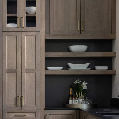 A close up of the Floating Shelves with black stain behind them and at the back of the glass door cabinets. This amazing Dura Supreme kitchen is full of beautiful design details and functional cabinet storage! Learn more about this kitchen and how it achieved multiple national awards in the Dura Supreme Cabinetry Blog! Duraform Drift Cabinets, Duraform Stone Cabinets, Ebony Stained Cabinets, Prairie Style Kitchen, Dura Supreme Cabinets, Modern Prairie Style, Glass Door Cabinets, Cabinetry Ideas, Black Cabinetry