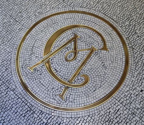 Club Monaco retro entry monogram tile work on the floor of their Fifth Avenue and 22nd Street, NYC store. Art Deco Round Floor, Mosaic Logo Design, Mosaic Lettering Floor, Brass Logo Signage, Terracotta Tile Floors, Mosaic Tile Lettering, Monogram Tile, Hall Flooring, Floor Ceiling