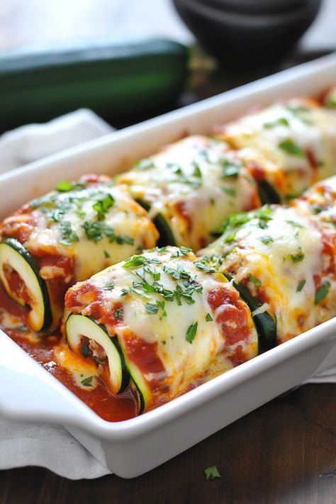 Zucchini roll-ups topped with melted cheese and parsley in a white baking dish. Zucchini Rollups With Ricotta, Zucchini Lasagna Roll Ups, Ground Beef Ricotta, Healthy Zucchini Lasagna, Zucchini Roll Ups, Lasagne Roll Ups, Veggie Lasagna Recipe, Zucchini Lasagna Recipe, Turkey Ground