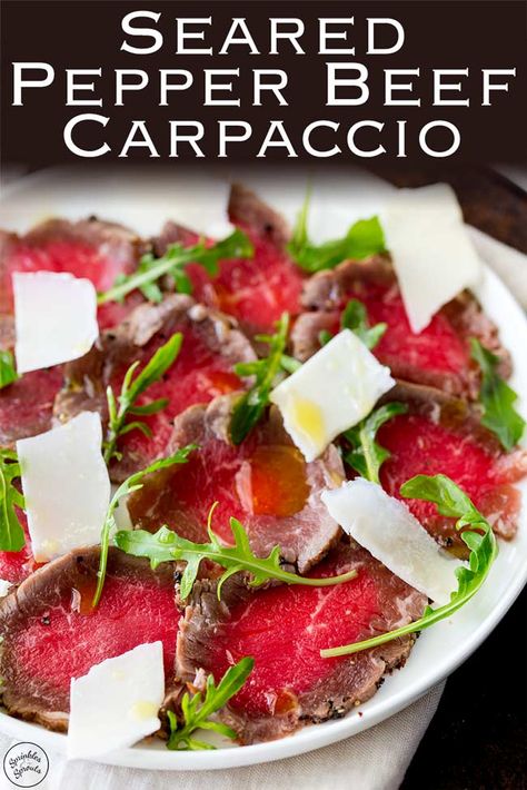 Learn how to make this restaurant quality beef carpaccio. With a recipe inspired by Jamie Oliver this seared pepper beef carpaccio makes the perfect elegant appetizer. This carpaccio also makes a smaller piece of beef fillet or beef tenderloin go a long way. #appetizer #christmas #posh #beeffillet #beeftenerloin Vegetable Carpaccio, Beef Tenderloin Carpaccio, Beef Carpaccio Appetizers, Eggplant Carpaccio, Steak Carpaccio, Beef Carpaccio Recipe, Carpaccio Recipe, Beef Appetizers, Dinner Party Appetizers