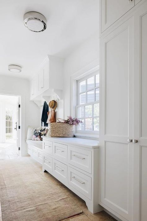 Mudroom And Laundry Room Combo, Dark Stained Wood Floors, Laundry Room Combo, Stacked Washer And Dryer, Black Storage Bench, Beadboard Trim, Built In Cabinetry, Cottage Laundry Room, Wood Shiplap Wall