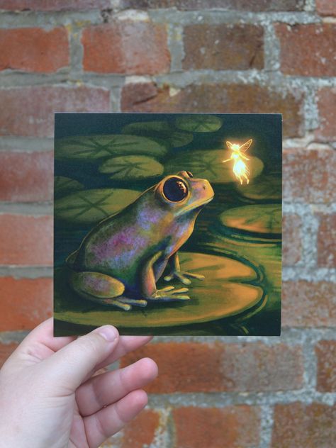 A Fairy Frog Encounter Square Print A print of an original digital painting - depicting a fairy meeting a frog at night in the local pond. PRODUCT INFO:  + Paper Type: Unicorn White + Paper Weight: Heavy (350 gsm) + Size: 148 mm x 148 mm + Colours displayed on your screen may look slightly different in real life due to your monitors/screens colour settings. SHIPPING INFO: + Prints will be mailed to you by Royal Mail First Class post (UK) and Royal Mail International Standard Shipping. OTHER INFO Things To Customize With Paint, Venus Fly Trap Painting Acrylic, Paintings People Will Buy, Enchanted Garden Painting, Slytherin Painting, Frog Painting Ideas, Fairy Painting Ideas, Watercolor Art Projects, Cute Frog Art