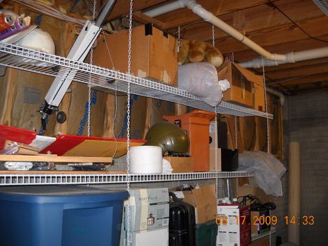 Hanging wire shelving:  It's relatively inexpensive, easy to hang wherever you want, easily reconfigurable for different heights and lengths, and bugs & dust just fall through to the floor where you can easily clean it up. Hanging Garage Shelves, Basement Shelving, Garage Wall Shelving, Hanging Storage Shelves, Laundry Room Storage Shelves, Ceiling Shelves, Overhead Garage Storage, Room Storage Diy, Basement Storage