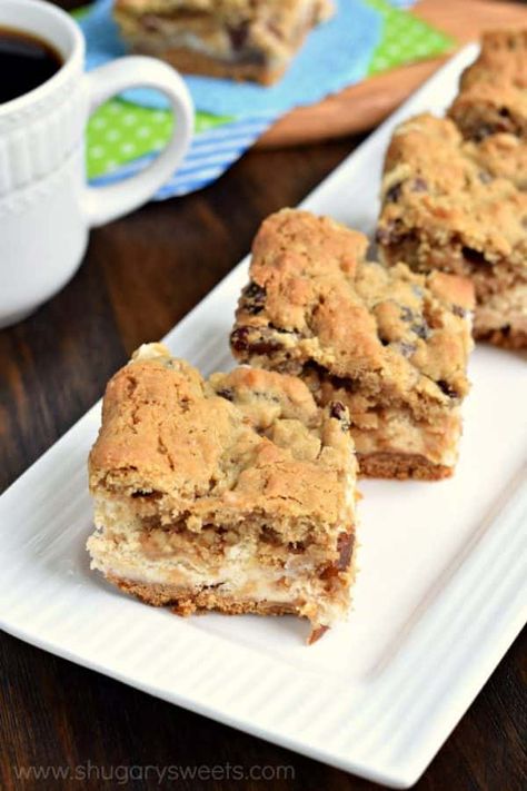 Soft and chewy oatmeal raisin cookie on top of a creamy cheesecake bar! These Oatmeal Raisin Cookie Cheesecake Bars are delicious, comfort food treats! Coconut Cream Poke Cake, Cookie Cheesecake Bars, Cream Poke Cake, Cheesecake Bar, Oatmeal Raisin Cookie, Cookie Cheesecake, Raisin Cookie, Oatmeal Raisin Cookies Chewy, Shugary Sweets