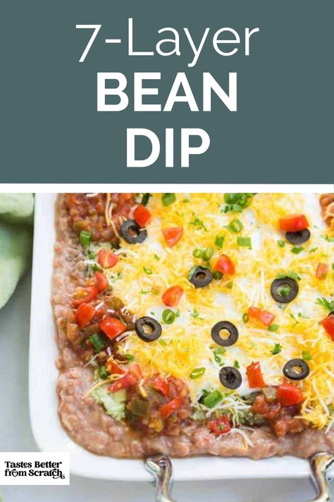 An image of a vibrant 7-layer bean dip, perfect for Super Bowl gatherings. LayerS including beans, guacamole, and cheese, creating a visually appealing and delicious appetizer. 7 Layer Bean Dip Recipe, Superbowl Dips, Bean Dip Appetizer, Layered Bean Dip Recipe, Super Bowl Food Dip, Layer Bean Dip, Easy Bean Dip, 7 Layer Bean Dip, Super Bowl Dips