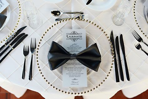 Sleek black napkins were folded into elegant bow-ties and set with the polished menu cards on gold beaded glass chargers 007 James Bond Party Decoration, 007 Wedding, James Bond Wedding, Bow Tie Napkins, Bond Wedding, James Bond Theme Party, 007 Party, Bond Party, James Bond Party