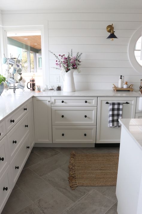 A really warm, inviting white kitchen with unique black cabinet hardware, wood plank on walls and love that tile on the floor! Decor Ikea, Classic Kitchen, Kitchen Floor Tile, Flooring Ideas, Beautiful Kitchen, Kitchen Remodeling Projects, Trendy Kitchen, White Kitchen Cabinets, Counter Tops