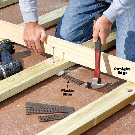 How to Build a Deck Over a Concrete Patio (DIY) | Family Handyman Deck Over Concrete, Diy Concrete Patio, Build A Deck, Concrete Patio Makeover, Laying Decking, Building A Patio, Front Porch Makeover, Concrete Patios, Floating Deck