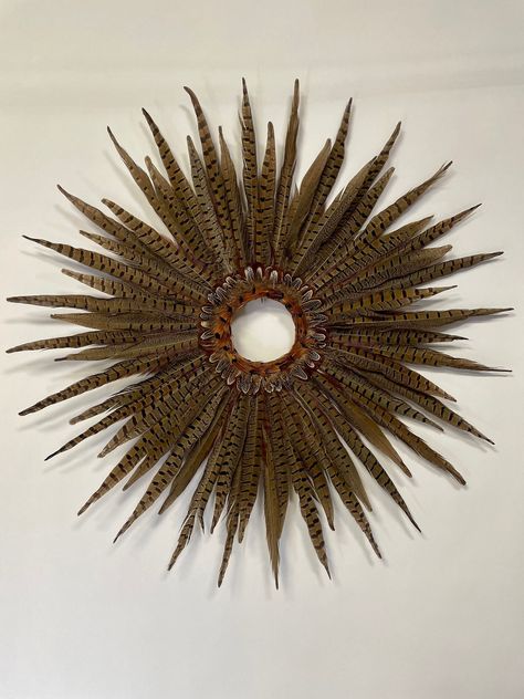 This item is MADE TO ORDER. Please allow time to process. Pheasant Star Feather Wreath is made with Natural Ringneck Pheasant Tail feathers and is 27.5 inches in diameter, approximately 2 inches thick. Made on a circular wooden base 8.5 inches in diameter with approximately a 3.75 inch opening at Cow Horns Decor, Pheasant Decor, Pheasant Feather Decor, Feather Wreaths, Holiday Window Display, Centerpiece Craft, Feather Centerpieces, Feather Wreath, Window Wall Decor