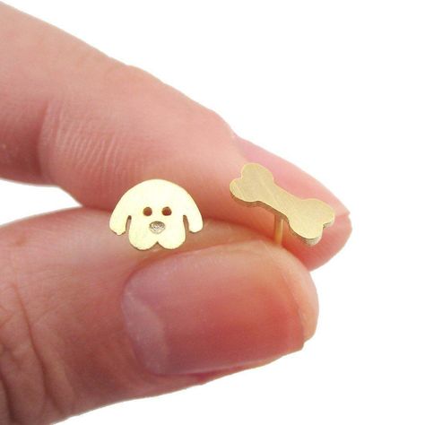 These minimal earrings are made in the shape of a dog's face and a dog bone in gold! They are super simple and made with allergy free posts for everyday wear Size: The dog stud measures 0.6 cm tall by 0.6 cm wide, the bone measures 0.8 cm wide by 0.3 cm tall. You get one of each to make a pair! Material: Gold Plated Brass charms, Titanium allergy free earring posts Store FAQ | Shipping Info | Returns & Exchanges Hamper Inspiration, Kids Studs, Cartoon Puppy, Super Cute Puppies, Tiny Puppies, Baby Hamper, Dog Earrings, Minimal Earrings