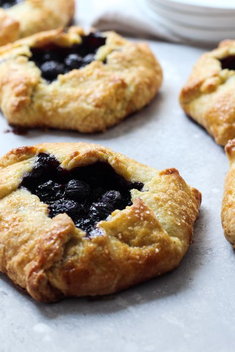 Blueberry Galettes are a delicious summer treat. They're made with a blueberry filling that has a hint of lemon and a cornmeal crust that is folded over for a rustic dessert. Serve this as a breakfast pastry or an afternoon treat with a scoop of vanilla ice cream. #blueberrygalette #cornmealcrust #thesweetoccasion Cornmeal Crust, Blueberry Galette, Blueberry Orange, Chocolate Hazelnut Cookies, Completely Delicious, Orange Dessert, Rustic Dessert, Hazelnut Cookies, Breakfast Pastries