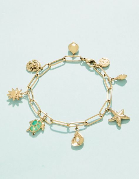 Make a splash with our Seashore Charm bracelet. Inspired by our favorite marine life, this piece shows our love for the sea. Designed to shine through everyday wear, exercise, showers and a summer at the beach in tarnish free 14kt gold vacuum plating. Summer Athstetic, Charm Bracelet Ideas, Gold Jewlry, Summer Jewlery, Beach Charm Bracelet, Summer At The Beach, Charm Bracelet Gold, Beach Jewellery, Surf Jewelry