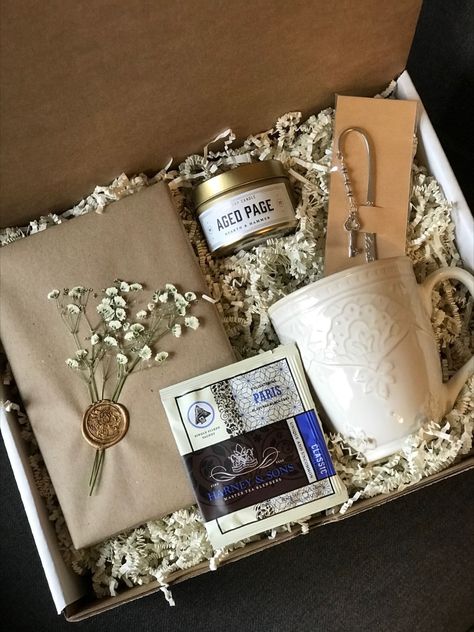 This booklover gift box features dried and pressed baby's breath fashioned with a gold wax seal.  A literary scented soy candle tin, generous tea mug and a handcrafted beaded shepherd hook bookmark compliments this cozy and unique gift!
www.etsy.com/shop/sparrowandpage
www.sparrowandpage.com Book Lover Gift Basket, Book Lovers Gift Basket, Tea Sachet, Harney And Sons Tea, Literary Candles, Blind Date With A Book, Date With A Book, Ideas Regalos, Book Baskets