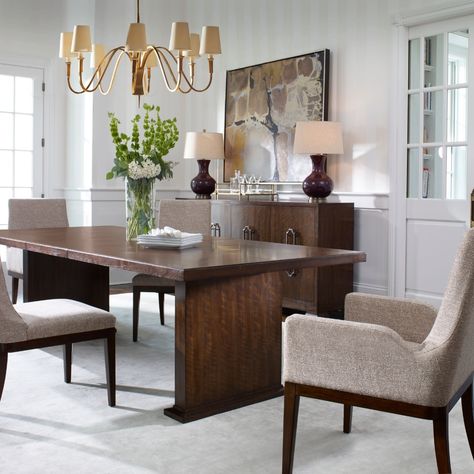 This captivating dining room includes a large dark brown table paired with beautiful upholstered chairs all set against pristine white walls and a white carpet. The artwork seamlessly combines all the shades of brown to help tie the space together. #KnoxvilleInteriorDesigner #InteriorDesign #HomeDecor #DiningRoomDesign White Dinning Room, Dining Room Apartment, Dining Room Brown, Dark Brown Table, Light Walls, Room Brown, Dark Furniture, White Carpet, Brown Table