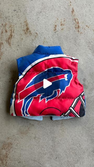 Upcycled gameday outfits on Instagram: "Puffer vest upcycled out from a vintage Buffalo Bills flag. Just about anything can be re-imagined onto a basic pattern. I did not make this pattern, I bought it off etsy! Will link the one i used in my bio :) Should I make more of these?? Got inspired to use this pattern after I saw @kristinjuszczyk make a 49ers one. I love how mainstream upcyling has become. Being intentional with the resources we already have is always more ethical than buying new. When you try this pattern, challenge yourself to use materials that are already in your closet (minus the thread and stuffing obviously, lol) Can’t wait to see what you guys create :)" Bills Game Day Outfit, Game Day Diy Outfit, Diy Puffer Vest, Buffalo Bills Outfit Woman, Football Jacket Outfit, Buffalo Bills Diy, Vest Pattern Sewing, Buffalo Bills Outfit, Sports Jersey Outfit