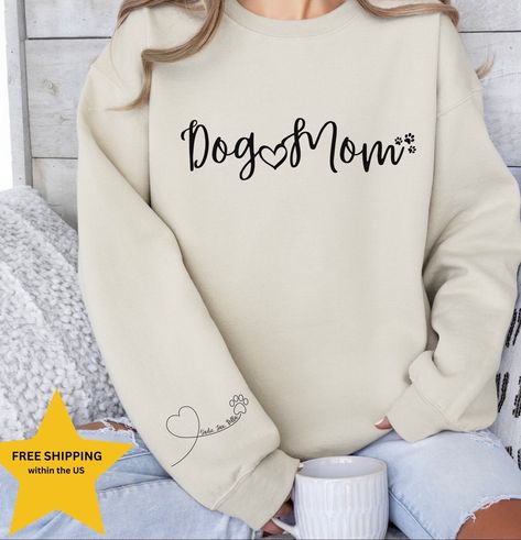 "Dog Mom Sweatshirt, Sleeve Print Dog Names, Personalized Dog Mom sweatshirt, Personalized Dog Mom Shirt, Dog mom personalized gift, Dog Mom Personalized shirt, Dog Mama Sweatshirt, Paw with Heart, Dog Lover Sweatshirt, Dog Mom Sweatshirt, Gift for Mom, Dog lover gift idea. Custom dog mom sweatshirt, personalized gift, dog mom shirt, personalized mama shirt.  HIGH QUALITY GILDAN SWEATSHIRT  1- Select your size 2- Select your color 3- Select the Quantity 4- Add your pets names to the personalization box 5- Click \"Add to cart\" button Note: For multiple items go back to the listing and repeat the steps above SIZE AND COLORS: * Unisex Sizing * Tear away label * Soft & Stylish * Retail fit PROCESSING TIME: The standard processing time is 1-3 business days. (We usually process and ship out the Dog Lover Sweatshirt, Dog Mom Tee, Dog Mom Sweatshirt, Womens Sweatshirts, Mommy Shirts, Lover Sweatshirt, Fur Mama, Gildan Sweatshirt, Mama Tee