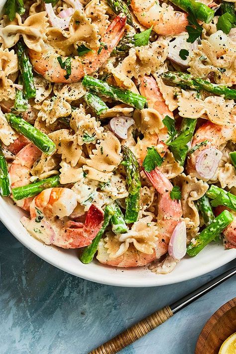 This fresh and bright cold shrimp pasta salad features classic shrimp scampi flavors. Lemon and Dijon mustard brighten the dressing, and asparagus adds a nice crunch. Farfalle pasta works well with this dish, but any medium pasta shape will work.#pastasalad #pastasaladrecipes #seafoodrecipes #shrimprecipes #shrimppasta #shrimppastarecipes #seafoodrecipes Cold Shrimp Pasta Salad, Seafood Pasta Salad, Cold Shrimp, Shrimp Pasta Salad, Seafood Salad Pasta, Farfalle Pasta, Shrimp And Asparagus, Grape Salad, Fresh Asparagus