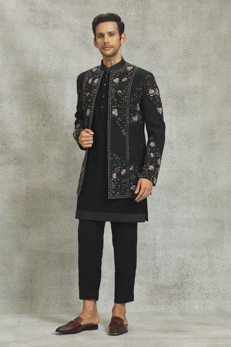 Black suiting shiny fabric hand embroidered jacket with floral patterns. Comes with sleeveless kurta and black trouser. Components: 3 Pattern: Hand Embroidered Type Of Work: Floral Neckline: Kurta: Mandarin Sleeve Type: Kurta: Sleeveless, Jacket: Full Fabric: Suiting Fabric Color: Black Other Details:  Front open jacket Kurta closure: Front button placket Occasion: Sangeet - Aza Fashions Long Koti Kurta For Men, Sleeveless Kurta, Kurta Set For Men, Pajama Pattern, Open Jacket, Suiting Fabric, Shiny Fabric, Floral Jacket, Suit Fabric