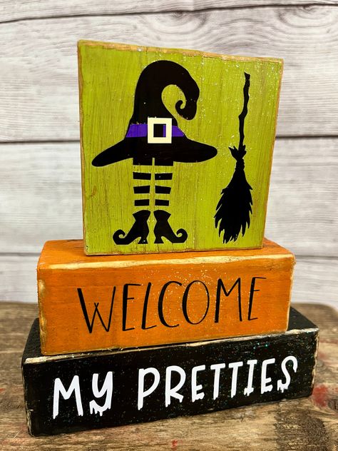 Add some spooky charm to your Halloween decor with this adorable "Welcome My Pretties" wood block stack. Perfect for adding a touch of seasonal fun to your shelf, mantel, tabletop, or desk. Handcrafted with love, these blocks will bring a smile to your face every time you see them. Perfect size for your desk! Get yours today and get ready to embrace the scary spirit! Blocks are not attached to each other  Dimensions - Set is approximately 5"x6".  We believe the value and beauty of handcrafted items is that each is truly one-of-a-kind as opposed to mass marketed home decor. We use reclaimed and hand painted wood, which gives each item its own personal character. When ordering an item, please expect there to be slight discrepancies in the wood grain, knots,  etc. Colors can sometimes look sl Halloween Shelf Decor Ideas, Halloween Diy Wood, Halloween Diy Door, Halloween Blocks, Fall Crafting, Desktop Table, Halloween Wood Signs, Easy Diy Halloween Decorations, Halloween Craft Projects