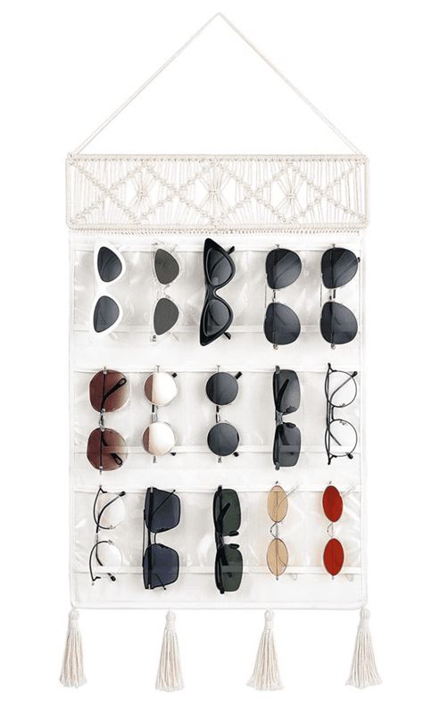 Sunglasses are a summer essential, but they can be a pain to store properly. If you’re not careful, the lenses can get scratched and the frames can become bent. Not to mention, it can be difficult to find them in a cluttered sunglasses drawer! That’s why we’ve put together a list of 10 creative ways... The post 13 Creative Ways to Store Your Sunglasses to Keep Them In Good Condition first appeared on Practical Perfection. Diy Sunglasses Holder, Eyewear Display, Sunglasses Organizer, Glasses Storage, Decorative Tassels, Sunglasses Storage, Tassels Decor, Closet Accessories, Macrame Hanging