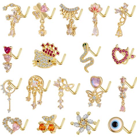 PRICES MAY VARY. 18 Unique Designs, Endless Style Options: This nose ring set includes 18 distinct designs, from regal crowns to playful cherries, featuring charming mini pendants that add a touch of personality to your look. Comfortable Fit, Durable Finish: Crafted with 18-gauge L-shaped nose rings, these pieces ensure a secure fit and are made with gold-plated alloy for lasting shine and color retention. Zirconia Sparkle, Mini Pendants: Each nose ring is adorned with brilliant zirconia stones Best Nose Rings, Fun Nose Rings, 18g Nose Ring, Cute Nose Rings, Heart Nose Rings, L Shaped Nose Ring, Medusa Piercing, Gold Nose Stud, Nose Piercings