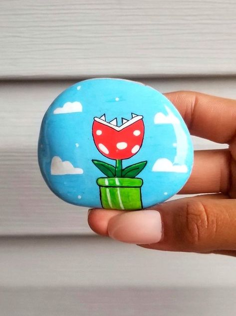 Rock Painting Ideas Mario, Mario Rock Painting Ideas, Mini Painted Rocks, Painting Rocks Aesthetic, Mario Painted Rocks, Mario Rock Painting, Cute Things To Paint On Rocks, Painted Rock Garden Ideas, Cool Painted Rocks